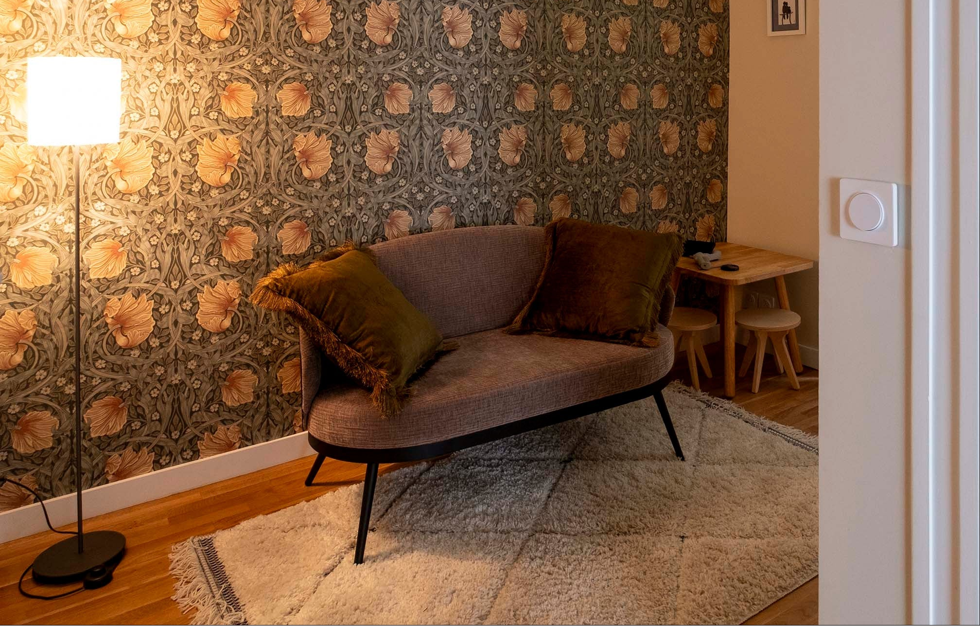 Transformation d'une entrée d'appartement en salle d'attente à Paris. pour un cabinet de psychologie. Décoration d’intérieur mêlant papier peint texturé, mobilier feutré et lumière douce pour créer un espace rassurant et intime.