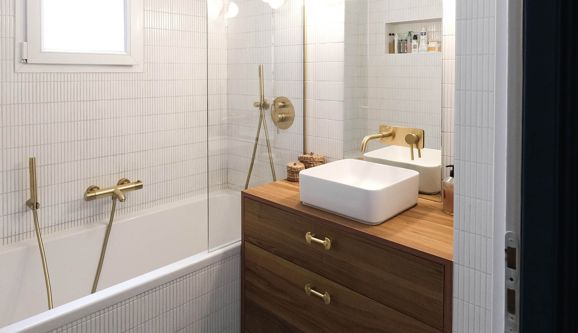 Architecture intérieure de salle de bain à Paris pour le projet de rénovation d'un appartement haussmannien rue Convention à Paris. Meuble vasque en bois et robinetterie en laiton brossé.